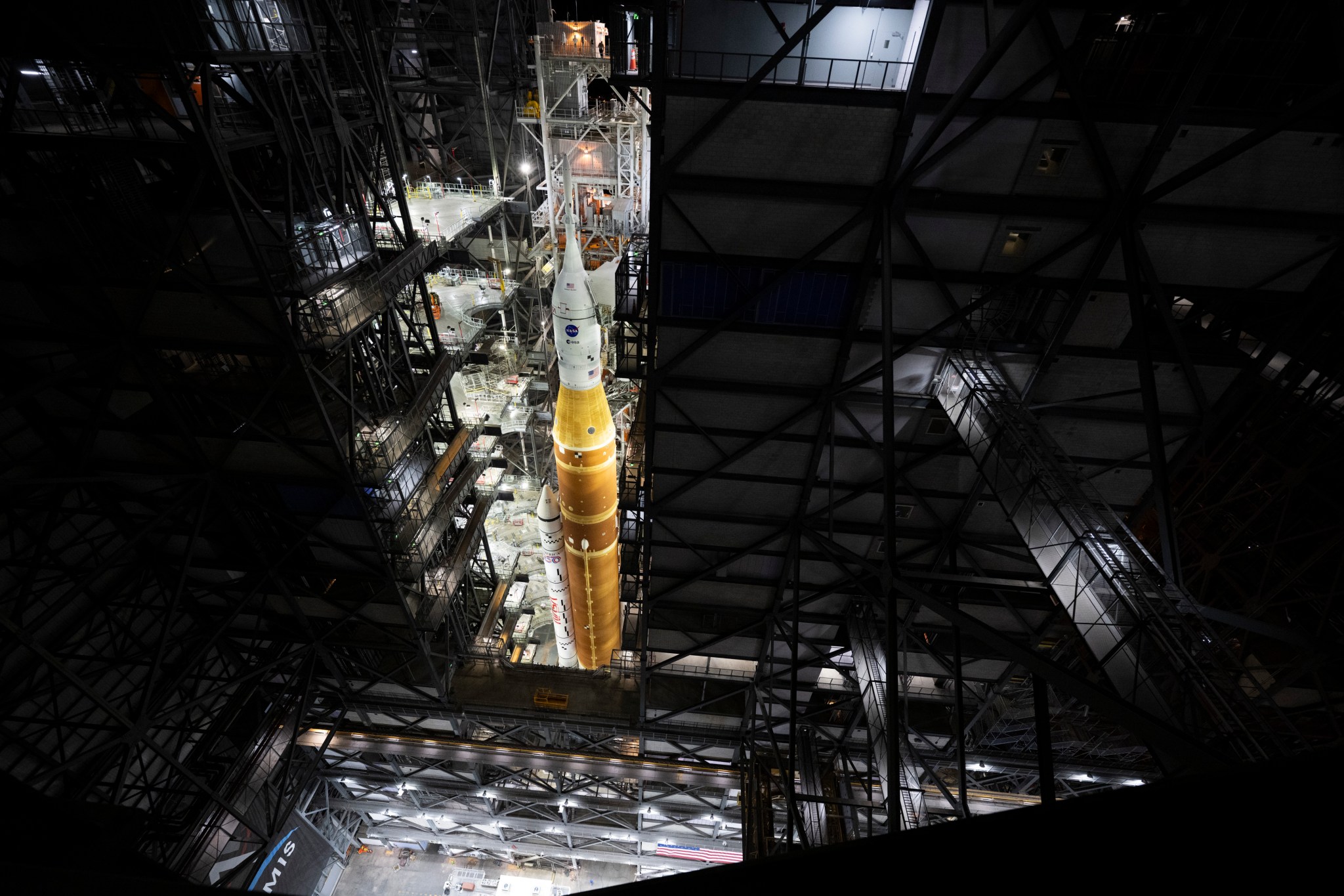 NASA"s orange SLS (Space Launch System) rocket, with the Orion spacecraft on top stands inside the Vehicle Assembly Building at the agency's Kennedy Space Center in Florida.