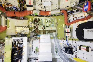 Interior of the Orion spacecraft, including a complicated system of hoses and cables.