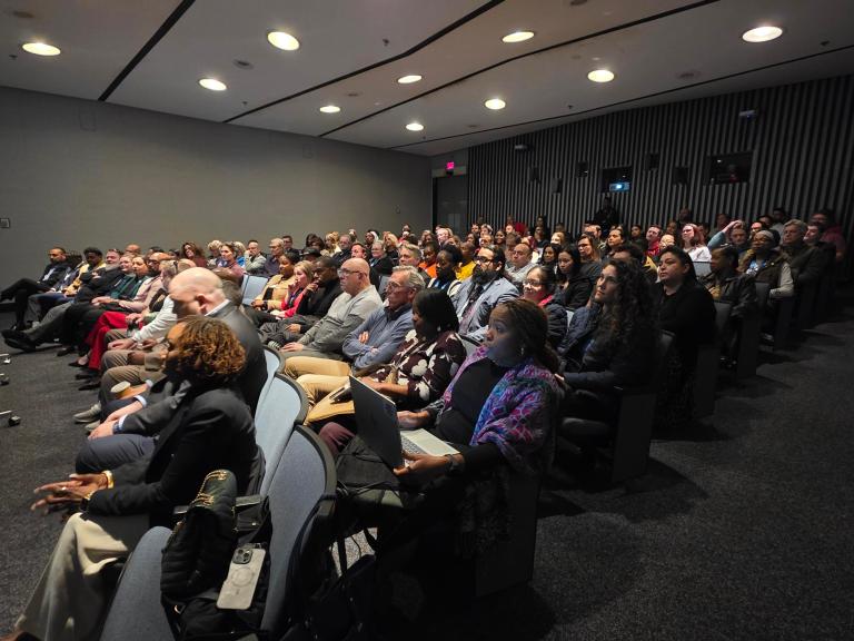 Senior members of the Office of Procurement gather for a presentation
