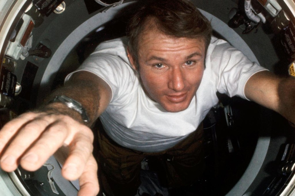 Vance Brand floating through the hatchway between the Apollo and Soyuz spacecraft