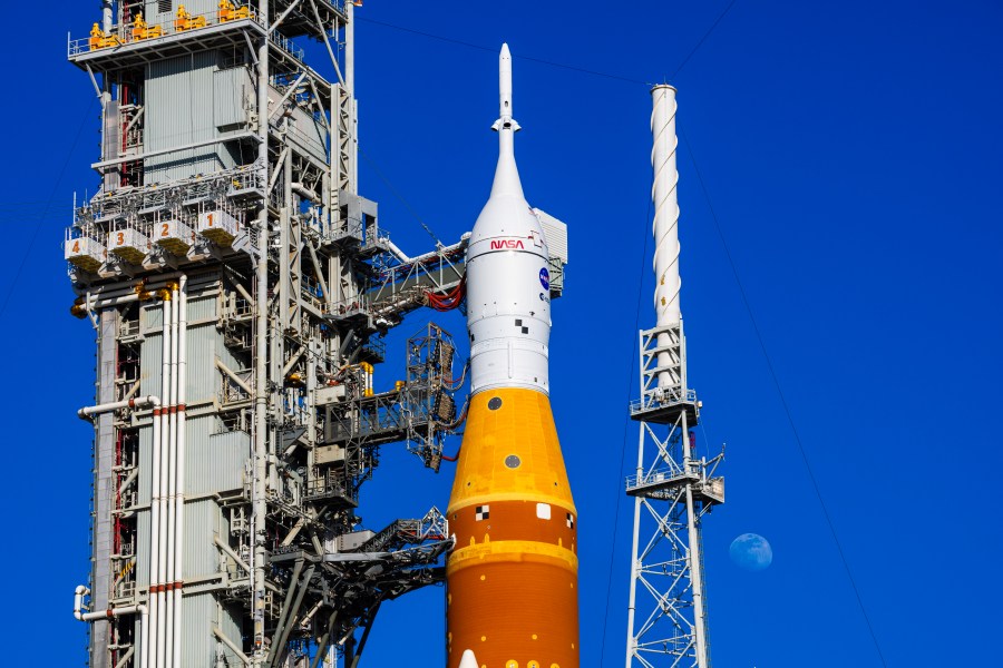 The Moon is seen behind the SLS (Space Launch System) and Orion spacecraft, atop the mobile launcher on January 28, 2026. The rocket is currently at Launch Pad 39B at NASA’s Kennedy Space Center in Florida, as teams are preparing for a wet dress rehearsal to practice timelines and procedures for the launch of Artemis II. 508 Description:The Moon is seen shining over the SLS (Space Launch System) and Orion spacecraft, atop the mobile launcher on January 29, 2026. The rocket is currently at Launch Pad 39B at NASA’s Kennedy Space Center in Florida, as teams are preparing for a wet dress rehearsal to practice timelines and procedures for the launch of Artemis II.