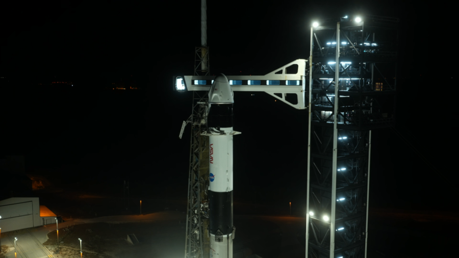 Image shows a night time sky with a white and black SpaceX Falcon 9 rocket and spacecraft in Florida. Photo credit: NASA