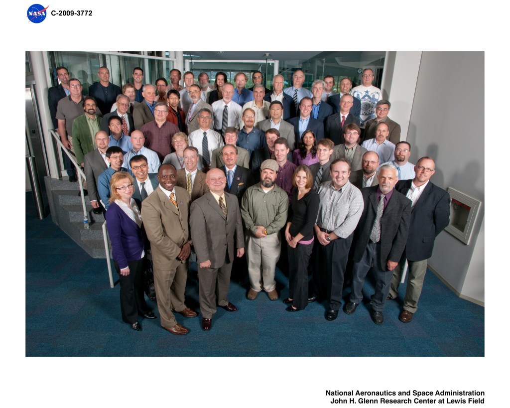 A group of people standing together and posing for a photograph.