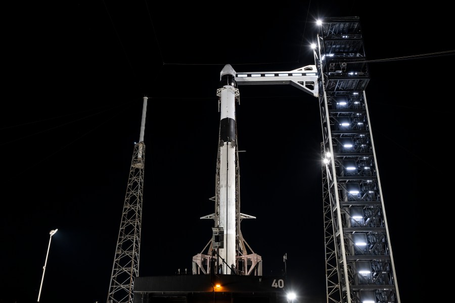 Image shows a night time sky with a white SpaceX Falcon 9 rocket and spacecraft at Space Launch Complex 40 at Cape Canaveral Space Force Station in Florida for the Crew-12 mission. Photo credit: SpaceX