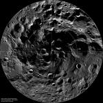 Mosaic image of the lunar South Pole showing a heavily cratered landscape with permanently shadowed regions near the pole and circular reference markings overlaid on the surface.