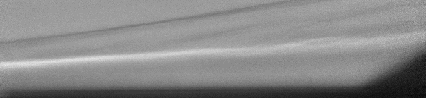 A black-and-white moving image shows swirlingair moves around a model wing. It appears mostly gray with lighter gray and white lines going horizontally across the image.