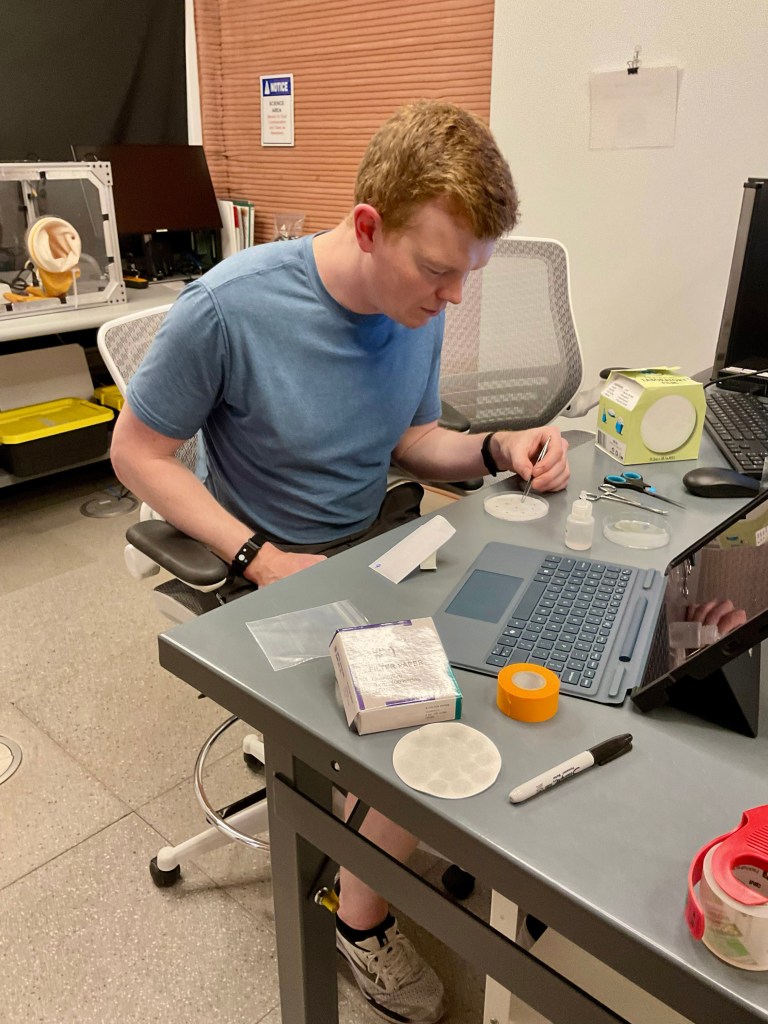 Crew Health and Performance Exploration Analog (CHAPEA) Mission 2 flight engineer, James Spicer, working on a science task involving seed germination.