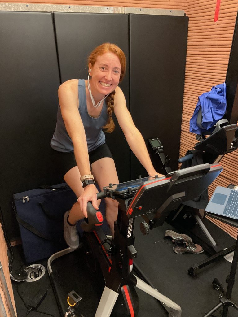 Crew Health and Performance Exploration Analog (CHAPEA) Mission 2 medical officer, Ellen Ellis, exercising in the habitat using a stationary bike.