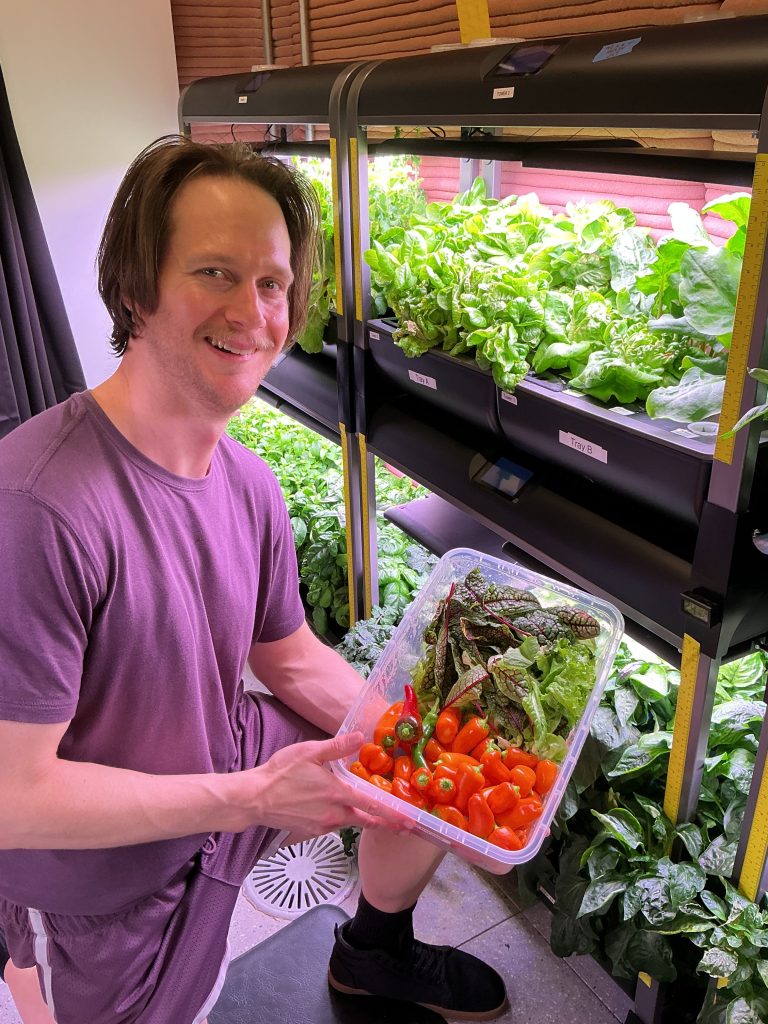 Matthew Montgomery, Crew Health and Performance Exploration Analog (CHAPEA) Mission 2 science officer, showcases vegetables collected during a recent harvest from the hydroponic crop growth system!