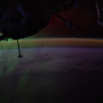 A wispy green aurora australis fades into a dim orange-yellow airglow above Earth’s horizon in this photograph taken at approximately 2:31 a.m. local time from the International Space Station, as it orbited 270 miles above the Indian Ocean, south of Perth, Australia.