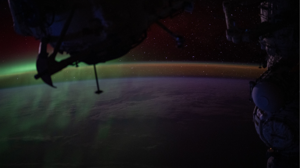 A wispy green aurora australis fades into a dim orange-yellow airglow above Earth’s horizon in this photograph taken at approximately 2:31 a.m. local time from the International Space Station, as it orbited 270 miles above the Indian Ocean, south of Perth, Australia.