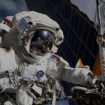 Pictured here, NASA astronaut Anne McClain conducts a spacewalk near one of the solar arrays to upgrade power systems and relocate a communications antenna.