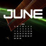A vibrant green aurora is visible on the arched horizon of the Earth. A portion of the space station is visible on the top part of the picture and one of the space station’s solar array wings is in front of the Earth.