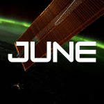 A vibrant green aurora is visible on the arched horizon of the Earth. A portion of the space station is visible on the top part of the picture and one of the space station’s solar array wings is in front of the Earth.