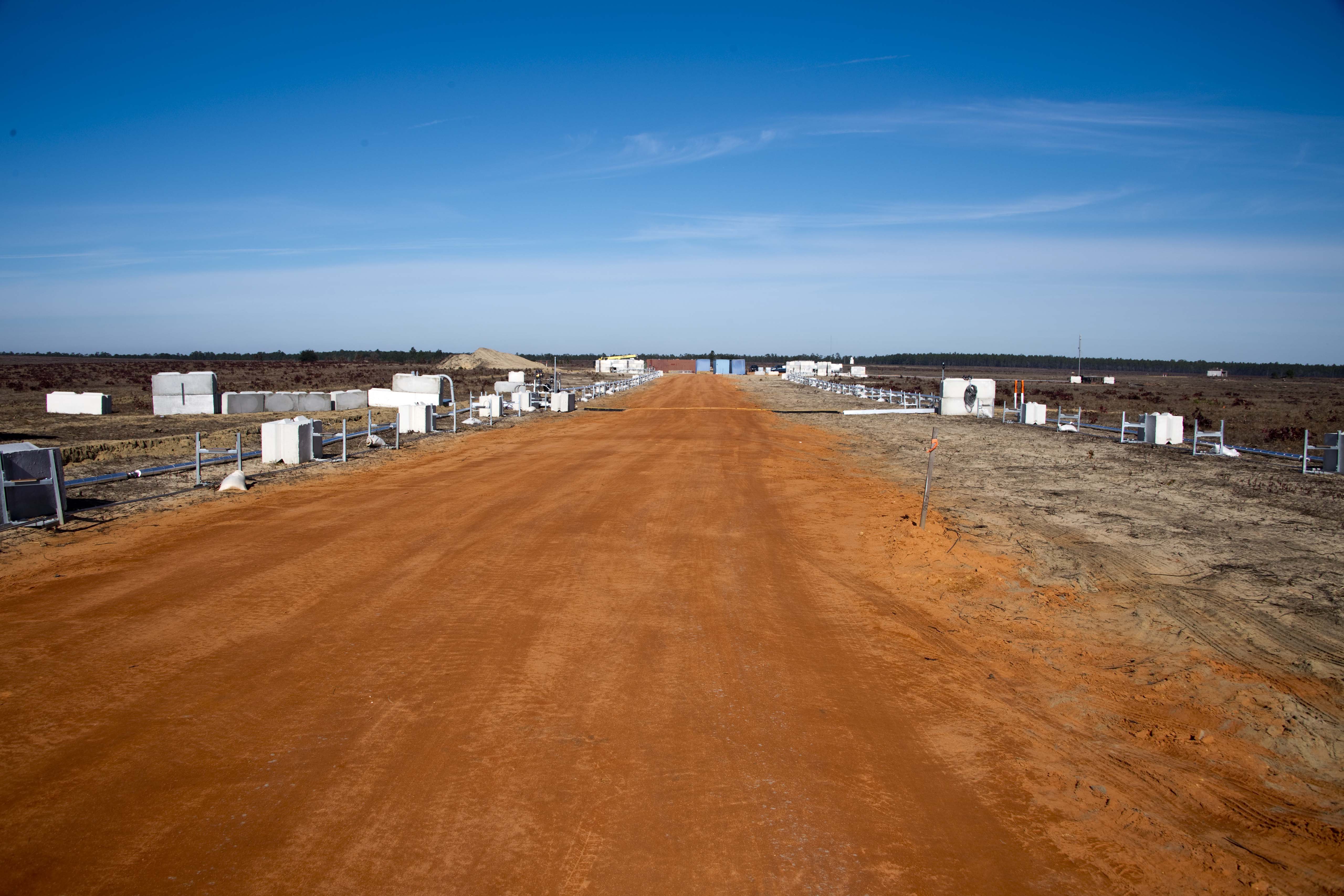 Test site at Eglin Air Force Base with propellant transfer lines leading to the cryogenic storage area.