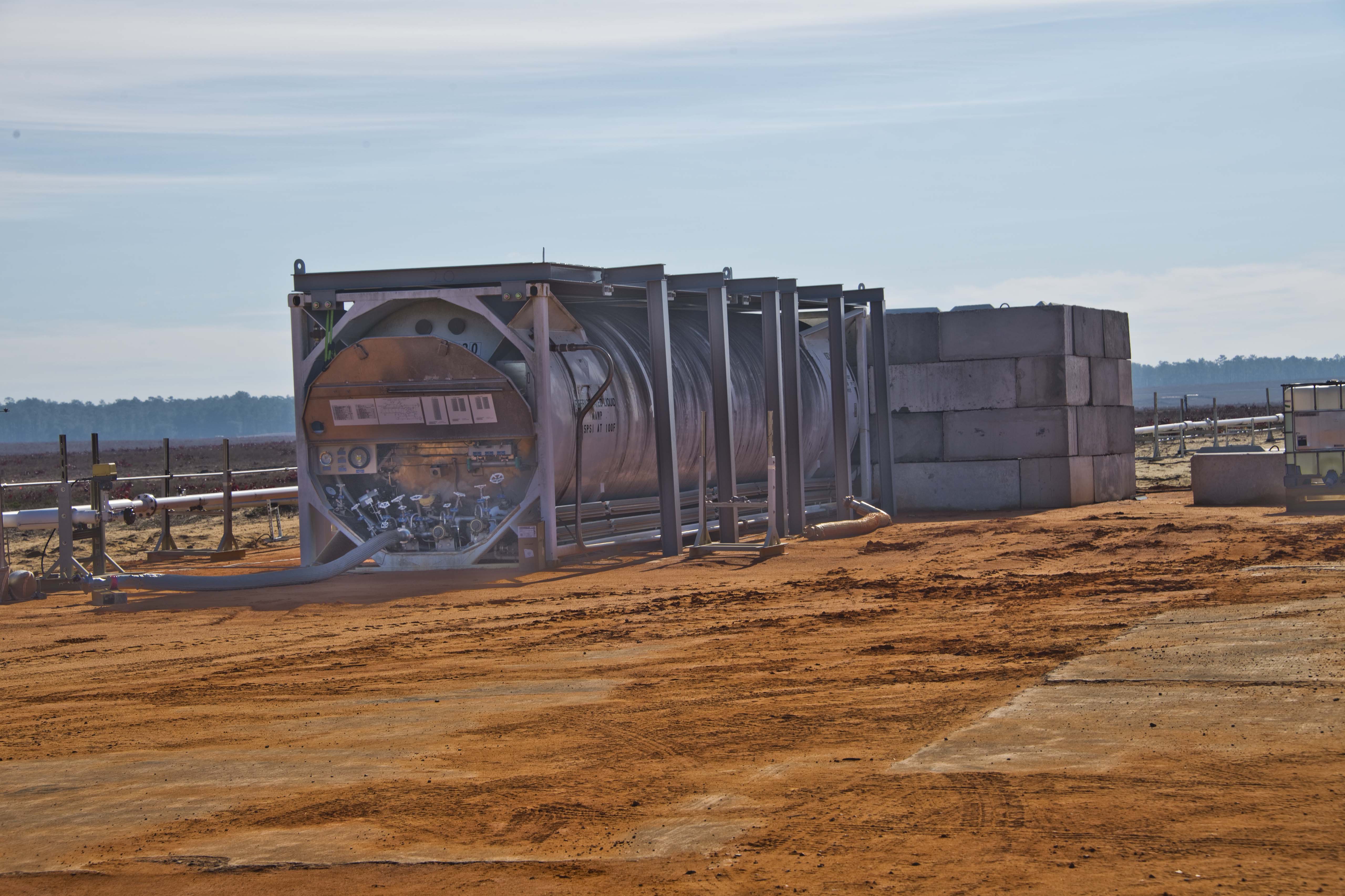 Cryogenic storage tank protected by a blast wall at the Eglin Air Force Base test site.