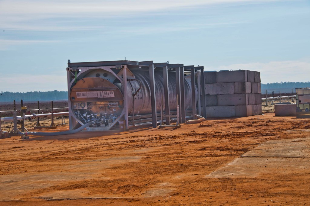 Cryogenic storage tank protected by a blast wall at the Eglin Air Force Base test site.