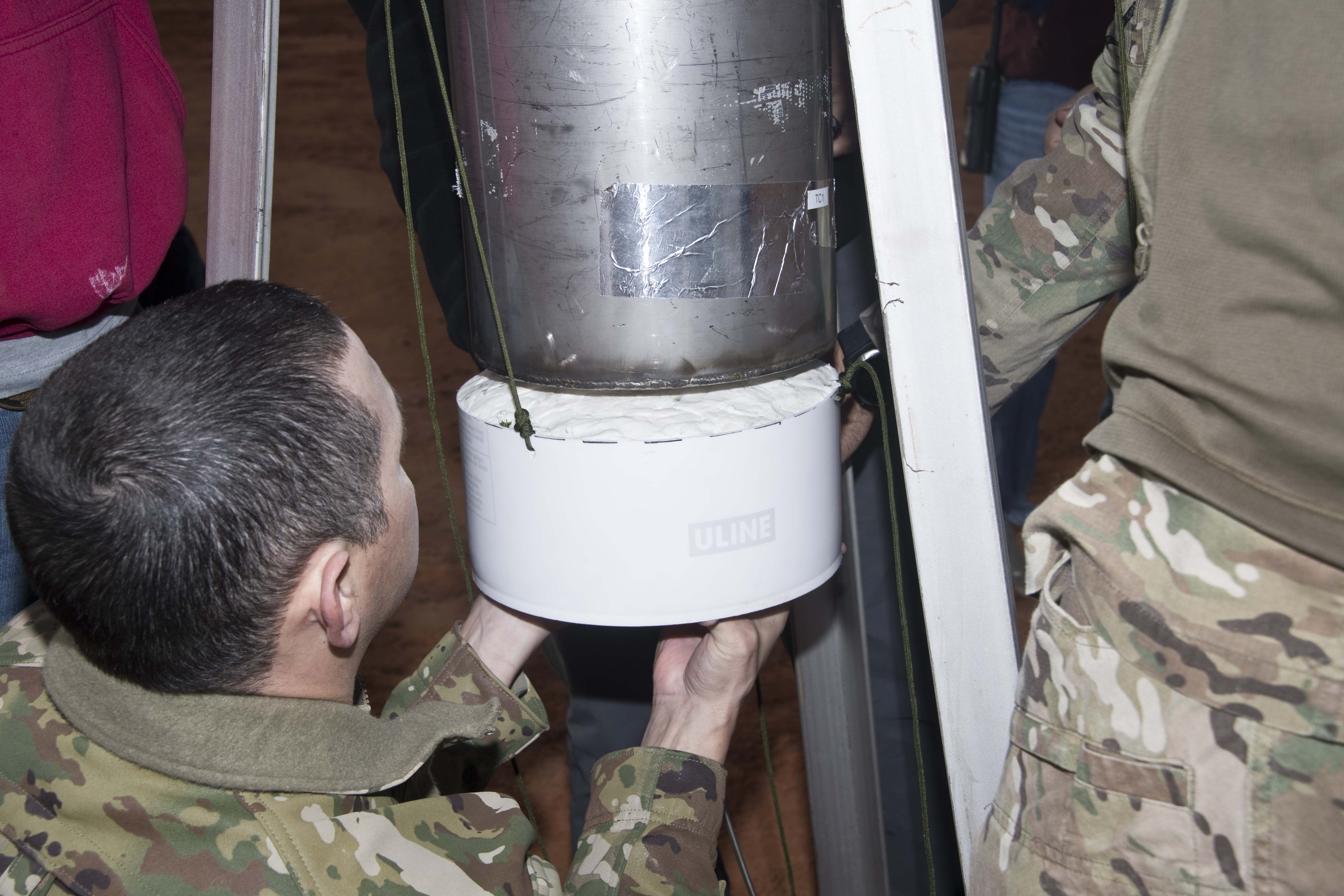 Team installing C-4 beneath the test article during preparation for the second baseline test.