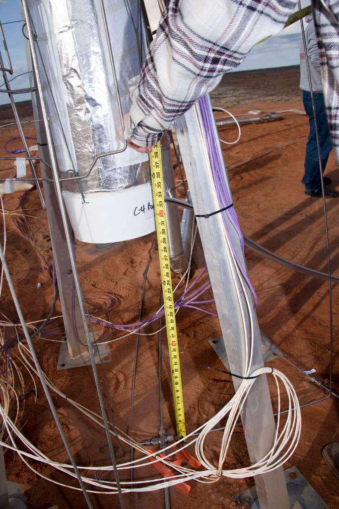 Personnel measure C‑4 installed beneath the test article.