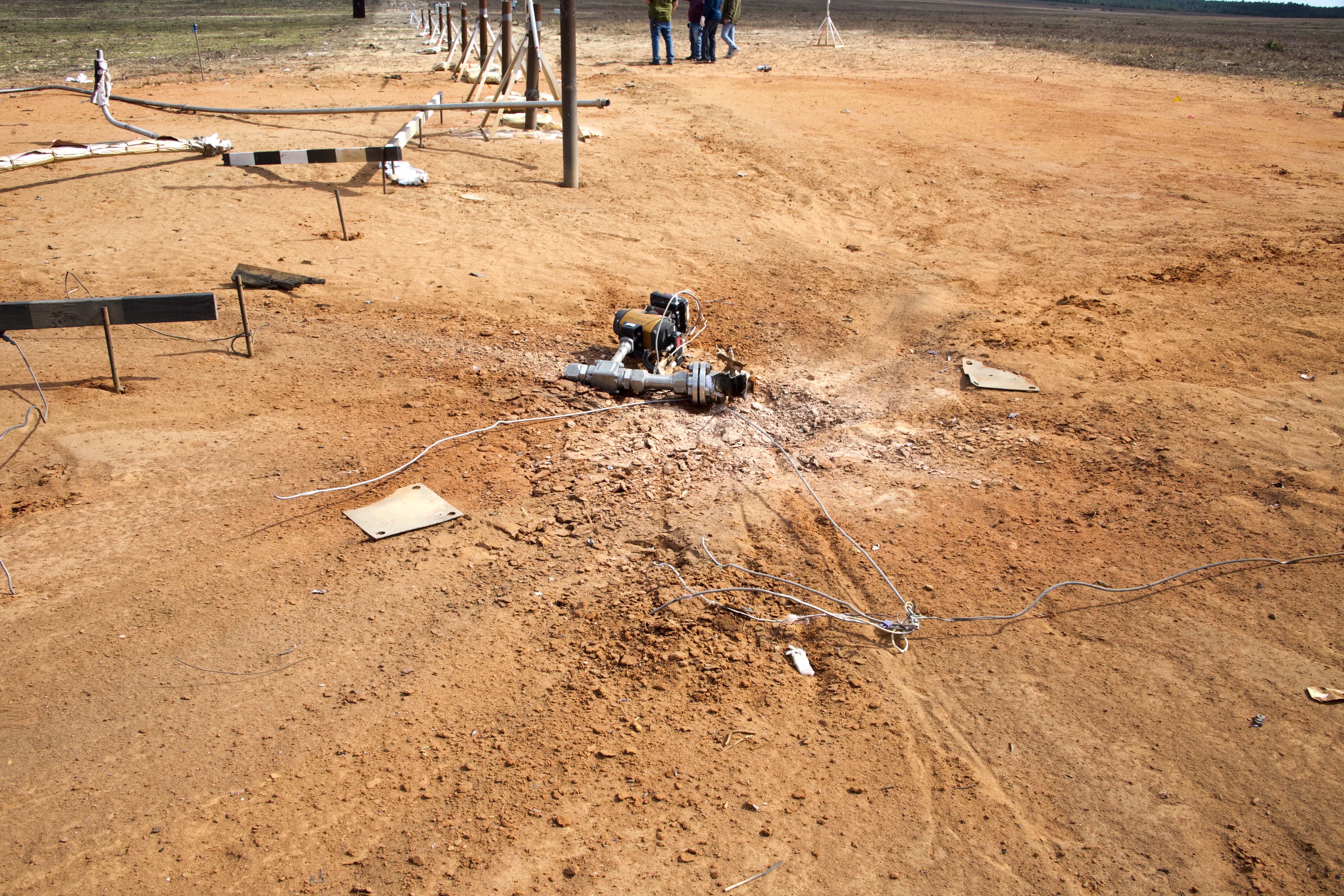 Center of blast area with detached fill valve on the ground.