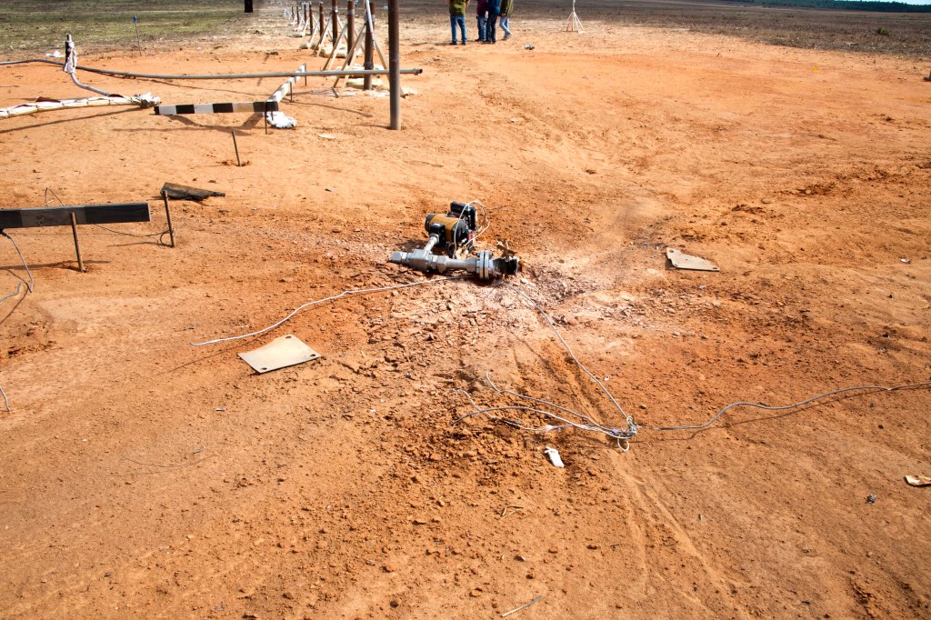 Center of blast area with detached fill valve on the ground.