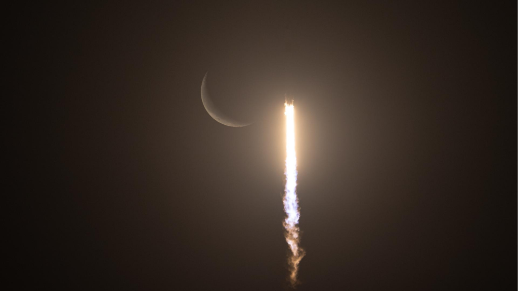 A SpaceX Falcon 9 rocket carrying the company's Dragon spacecraft is seen against the crescent Moon during the launch of NASA’s SpaceX Crew-12 mission to the International Space Station with NASA astronauts Jessica Meir, Jack Hathaway, ESA (European Space Agency) astronaut Sophie Adenot, and Roscosmos cosmonaut Andrey Fedyaev, Friday, Feb. 13, 2026, from Cape Canaveral Space Force Station in Florida. Meir, Hathaway, Adenot, and launched at 5:15 a.m. EST from Space Launch Complex 40 at the Cape Canaveral Space Force Station to begin their mission aboard the orbital outpost.