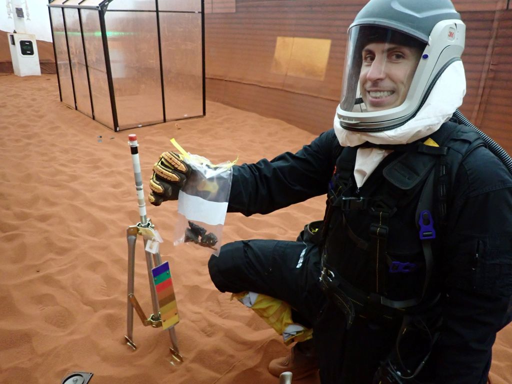 CHAPEA Mission 2 commander, Ross Elder, shows geological samples collected during a simulated extravehicular activity.