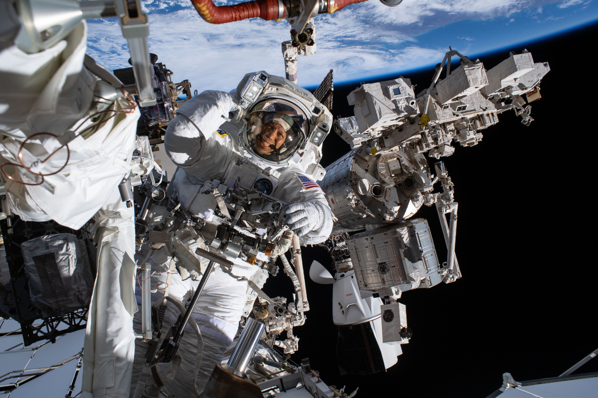 NASA astronaut Chris Williams smiles at the camera while conducting a spacewalk outside the International Space Station. Credit: NASA/Jessica Meir