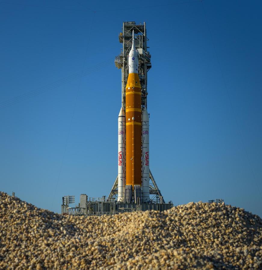 NASA’s Artemis II Space Launch System (SLS) rocket and Orion spacecraft are seen atop a mobile launcher at Launch Complex 39B, Friday, March 27, 2026, at NASA’s Kennedy Space Center in Florida. NASA’s Artemis II test flight will take Commander Reid Wiseman, Pilot Victor Glover, and Mission Specialist Christina Koch from NASA, and Mission Specialist Jeremy Hansen from the CSA (Canadian Space Agency), around the Moon and back to Earth with launch opportunities beginning in April 2026. Photo Credit: (NASA/Bill Ingalls)
