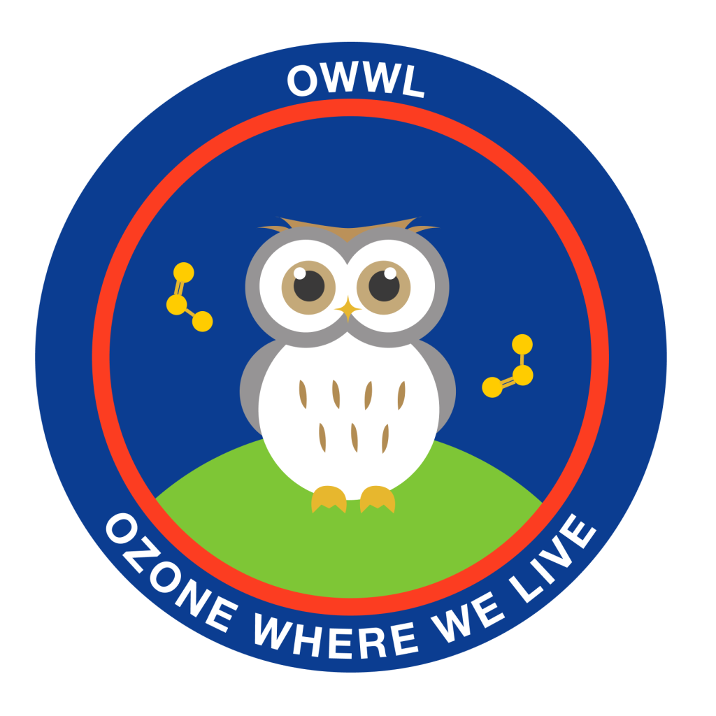 A round patch with a dark blue background and red ring. In the middle is a small green hill with a cartoon gray and white owl sitting on top, and gold molecules floating next to it. Text around the rim of the circle reads OWWL on top, and ozone where we live across the bottom.