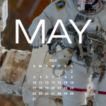 An astronaut in a white spacesuit is shown being maneuvered by the Canadarm2, which is attached to the space station, during a spacewalk.