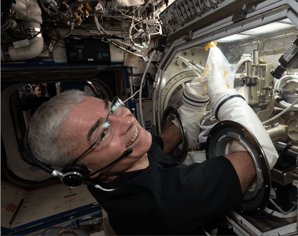 Expedition 65 Flight Engineer Mark Vande Hei works inside the U.S. Destiny laboratory module's Microgravity Science Glovebox for the Ring Sheared Drop fluid physics study (August 16, 2021)