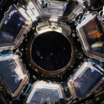 A picture of the cupola, the crew on the space station's "window to the world" with the month of March written on it and the calendar grid for March.