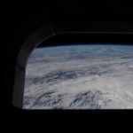 CAPTION: art002e025469 (April 2, 2026) – View out of one of the Orion spacecraft's main cabin windows, looking back at Earth, as the crew travels towards the Moon. Credit: NASA