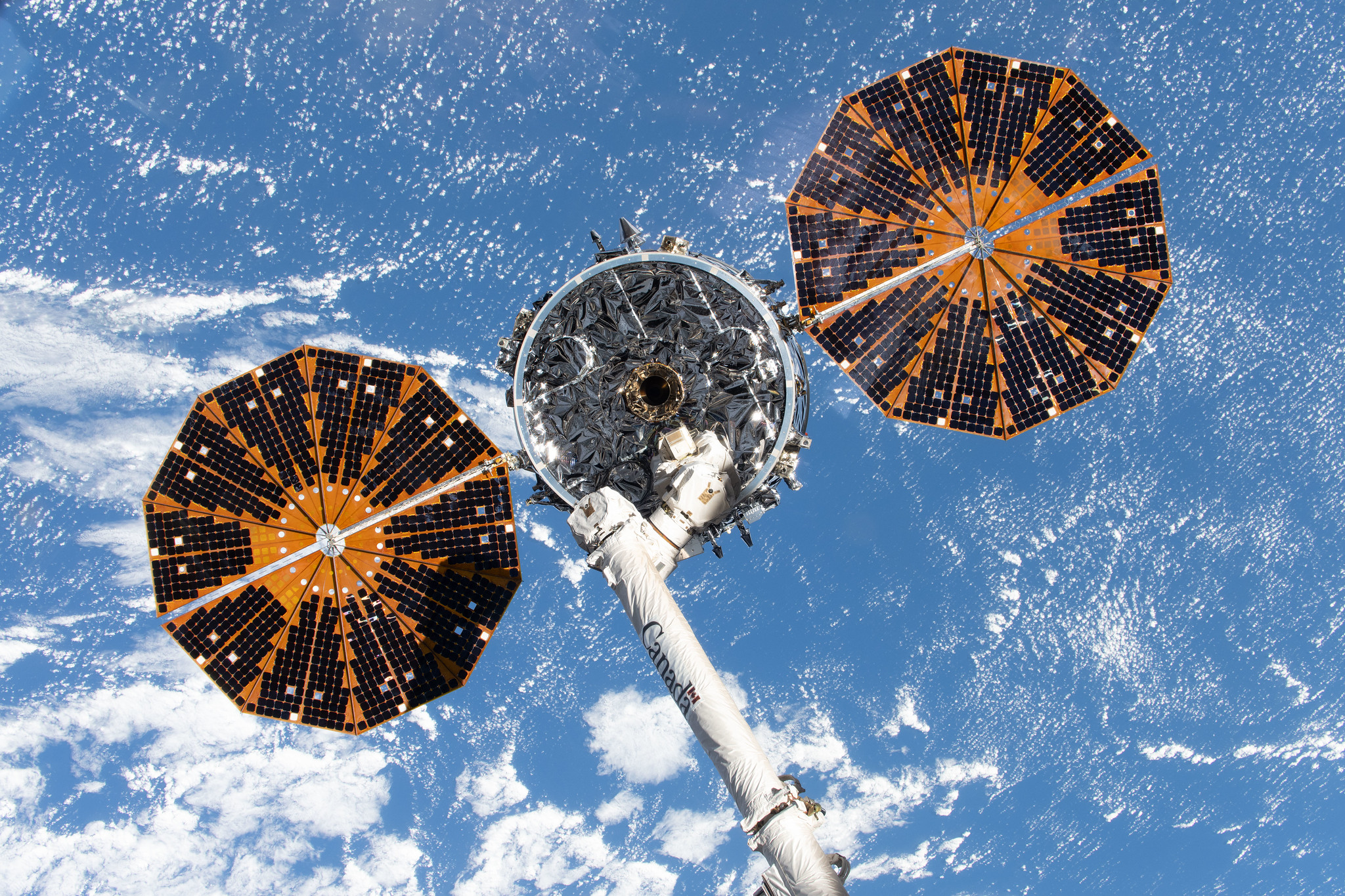 iss074e0378294 (March 12, 2026) --- Northrop Grumman's Cygnus XL cargo spacecraft, with its two prominent cymbal-shaped UltraFlex solar arrays, is in the grasp of the Canadarm2 robotic arm before being released and departing the International Space Station to complete its resupply mission.