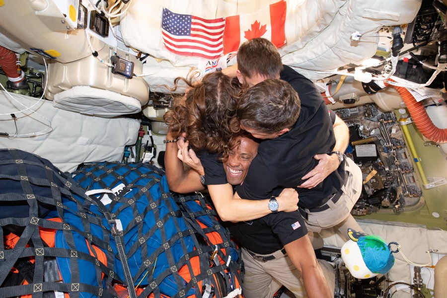 art002e013367 (April 7, 2026) – The Artemis II crew – (clockwise from left) Mission Specialist Christina Koch, Mission Specialist Jeremy Hansen, Commander Reid Wiseman, and Pilot Victor Glover – take time out for a group hug inside the Orion spacecraft on their way home. Following a swing around the far side of the Moon on April 6, 2026, the crew exited the lunar sphere of influence (the point at which the Moon's gravity has a stronger pull on Orion than the Earth's) on April 7, and are headed back to Earth for a splashdown in the Pacific Ocean on April 10. The crew was selected in April 2023, and have been training together for their mission for the past three years.