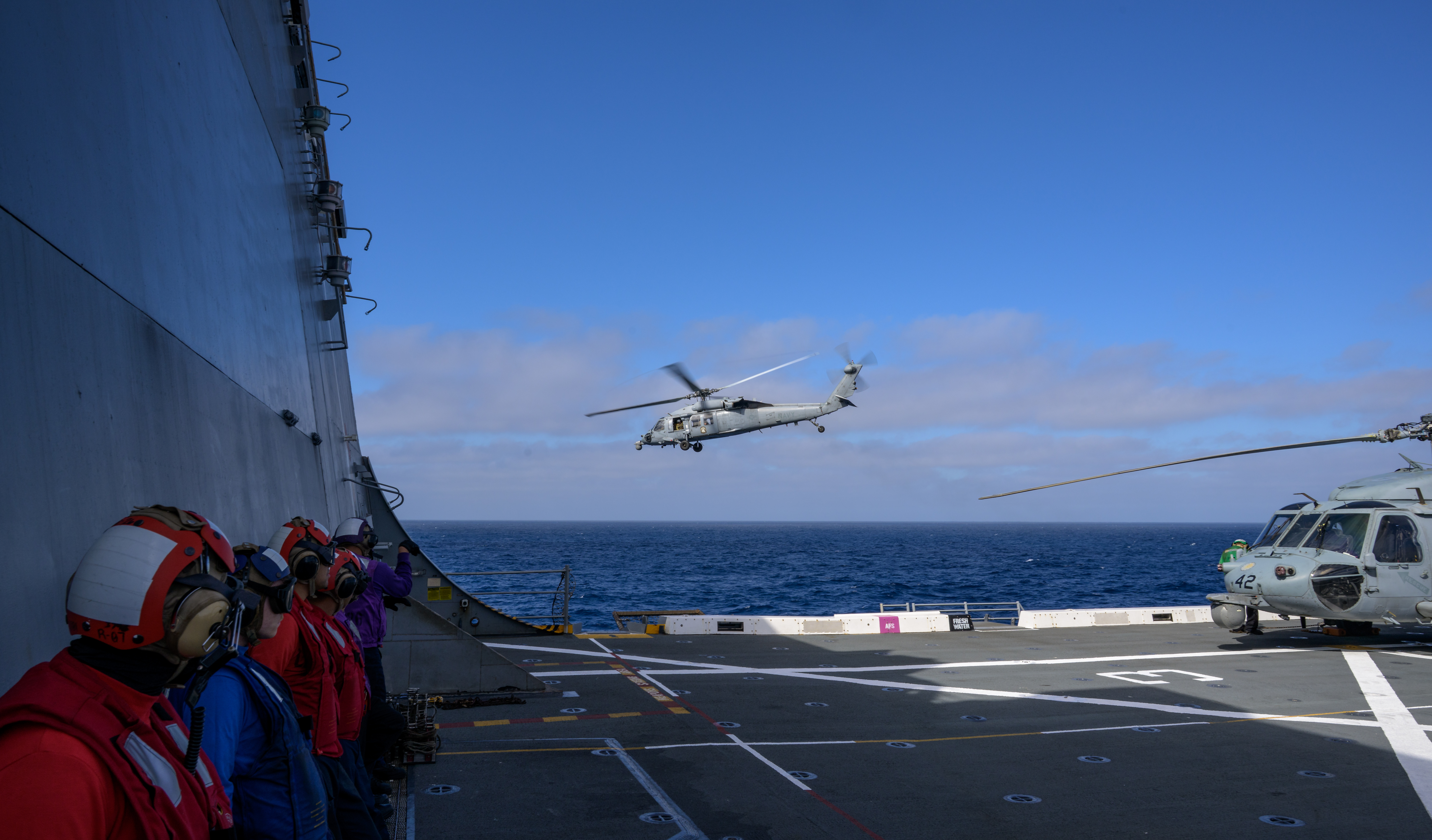 U.S. Navy MH-60 Seahawks from Helicopter Sea Combat Squadron (HSC) 23 depart USS John P. Murtha as they conduct air...