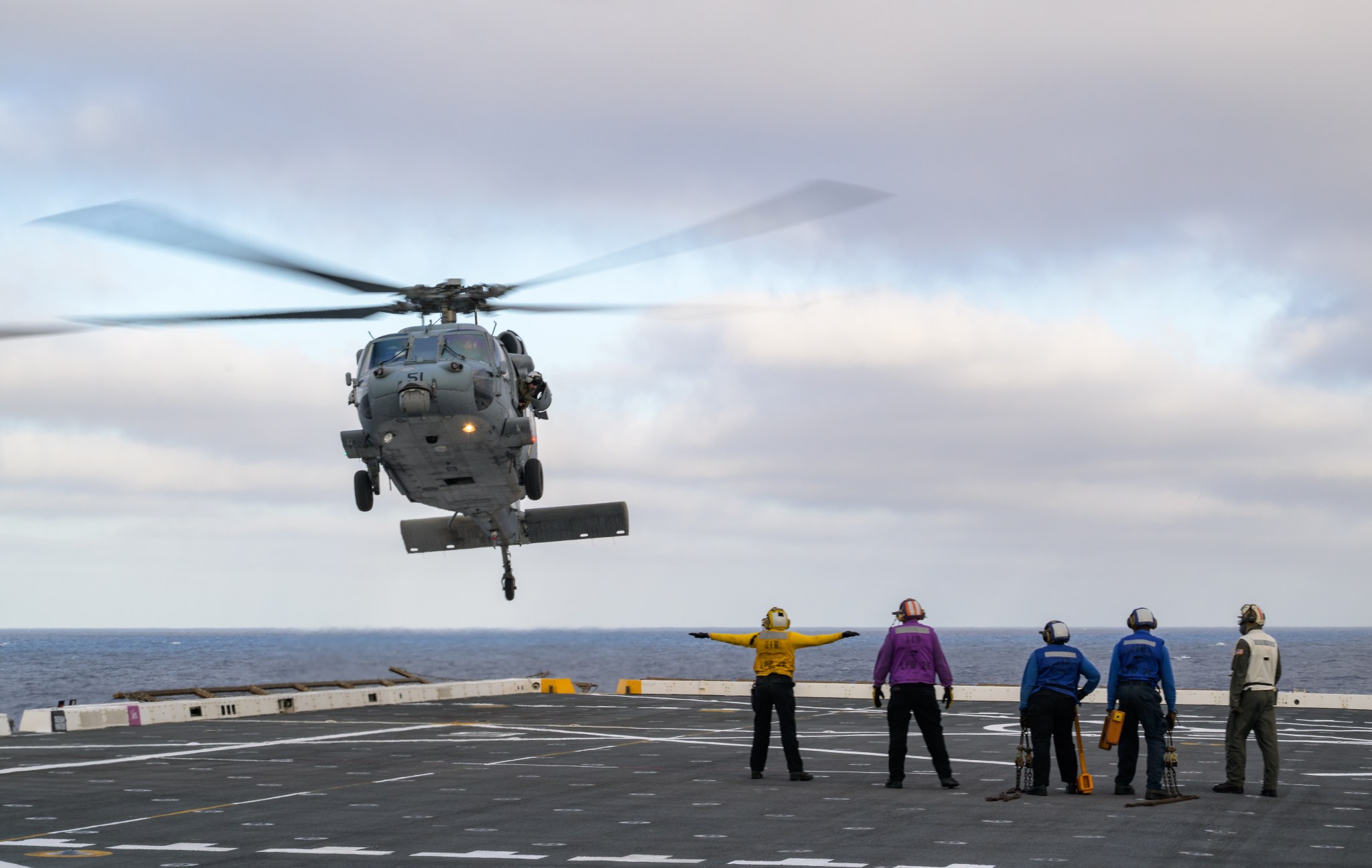 U.S. Navy MH-60 Seahawks from Helicopter Sea Combat Squadron (HSC) 23 are seen arriving on the flight deck of USS John P. Murtha as they prepare to conduct air operations training as NASA, U.S. Navy, and U.S. Air Force teams prepare for the the return of the Artemis II crewmembers to Earth, Monday, April 6, 2026, in the Pacific Ocean off the coast of California. NASA’s Artemis II mission is taking NASA astronauts Reid Wiseman, commander; Victor Glover, pilot; Christina Koch, mission specialist; and CSA (Canadian Space Agency) astronaut Jeremy Hansen, mission specialist on a 10-day journey around the Moon and back aboard their Orion spacecraft. Wiseman, Glover, Koch, and Hansen are scheduled to splash down off the coast of San Diego at approximately 5:07 p.m. PDT (8:07 p.m. EDT) on Friday, April 10.