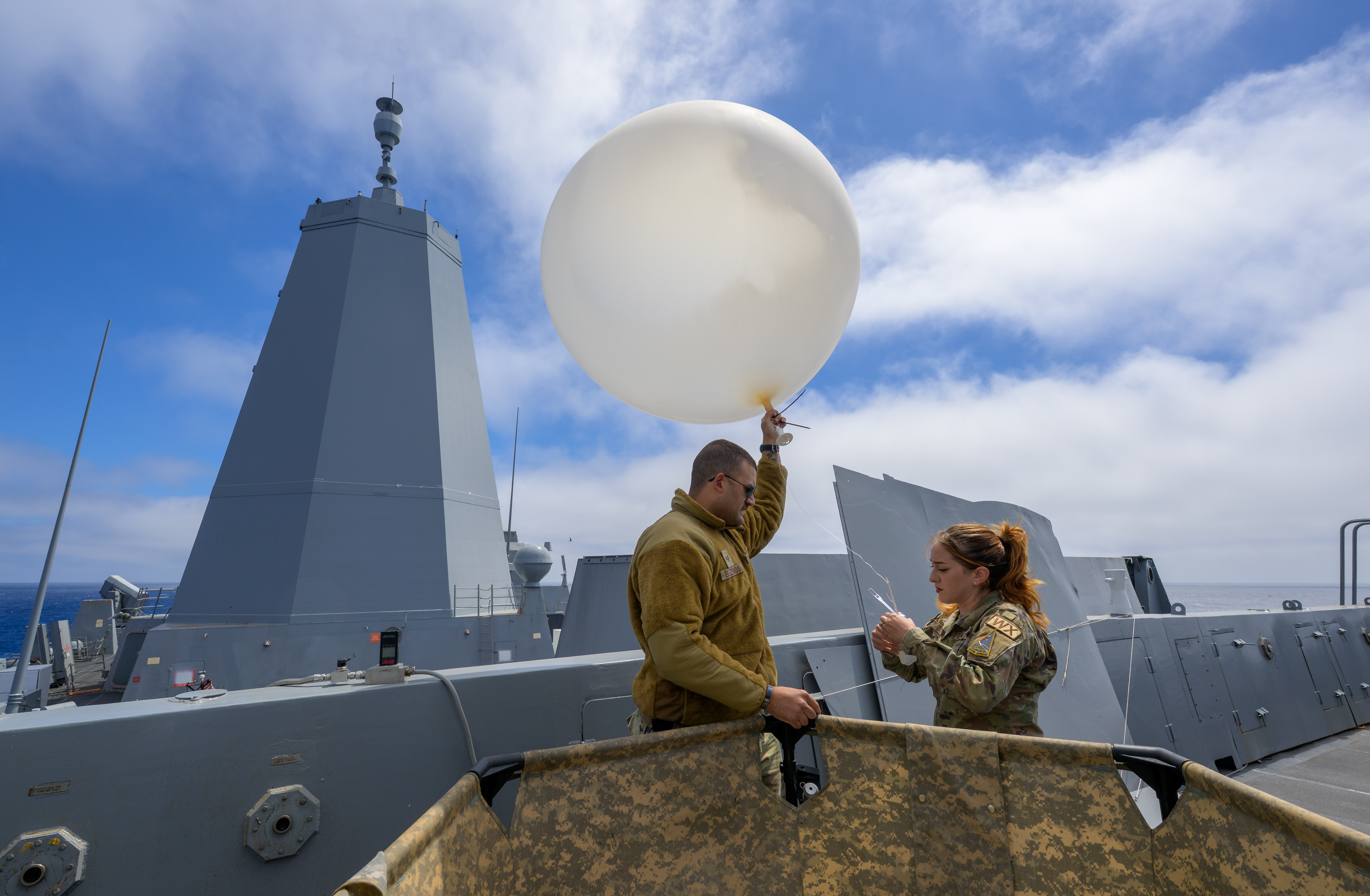 Airmen of the 45th Weather Squadron prepare a weather balloon for launch as NASA, U.S. Navy, and U.S. Air Force...