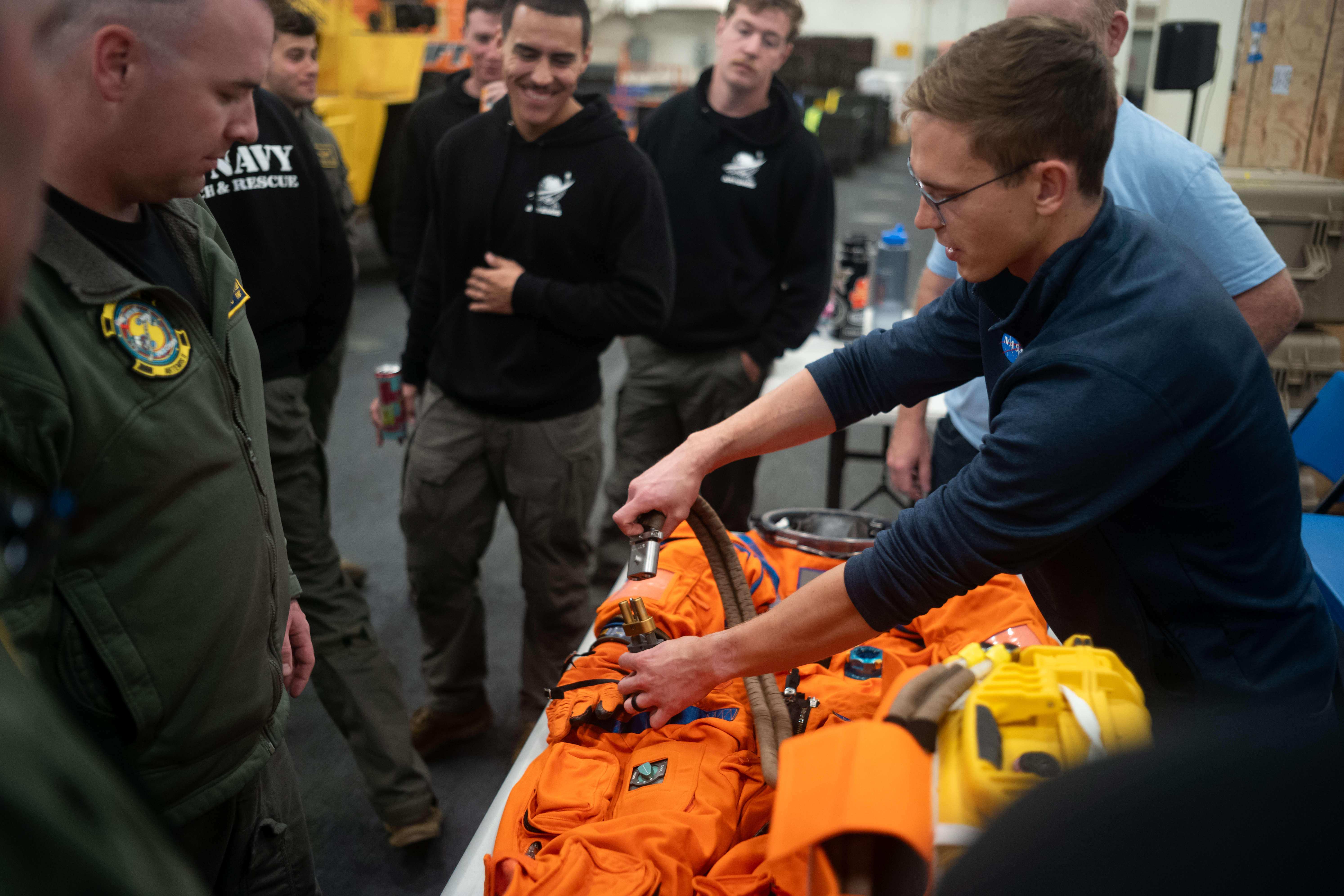 Nicholas Houghton, an Orion Crew Survival System engineer at NASA’s Johnson Space Center, left, conducts familiarization training with the Orion...