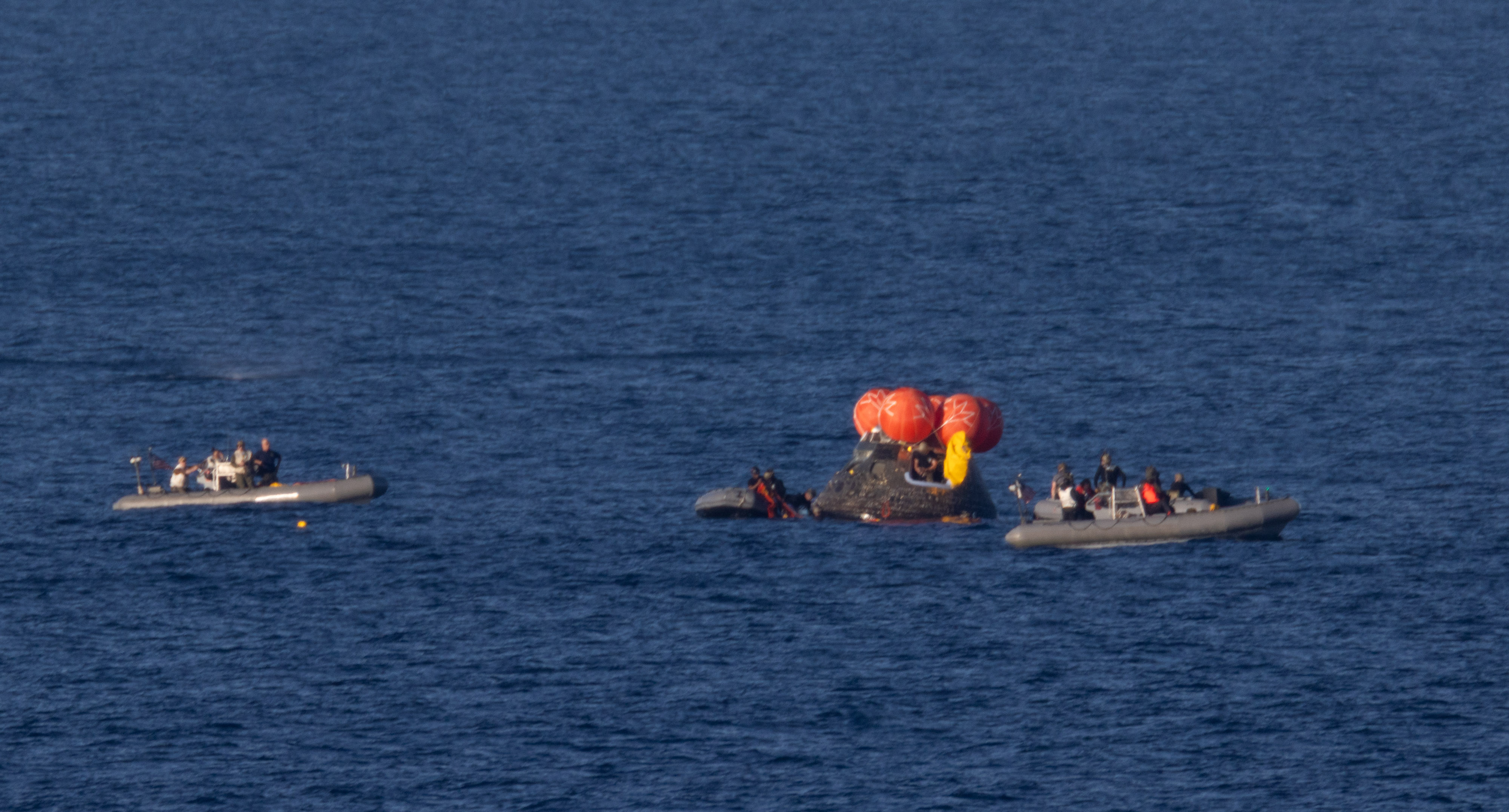NASA’s Orion spacecraft is seen as recovery teams work to secure the spacecraft ahead of transferring Artemis II crewmembers NASA...