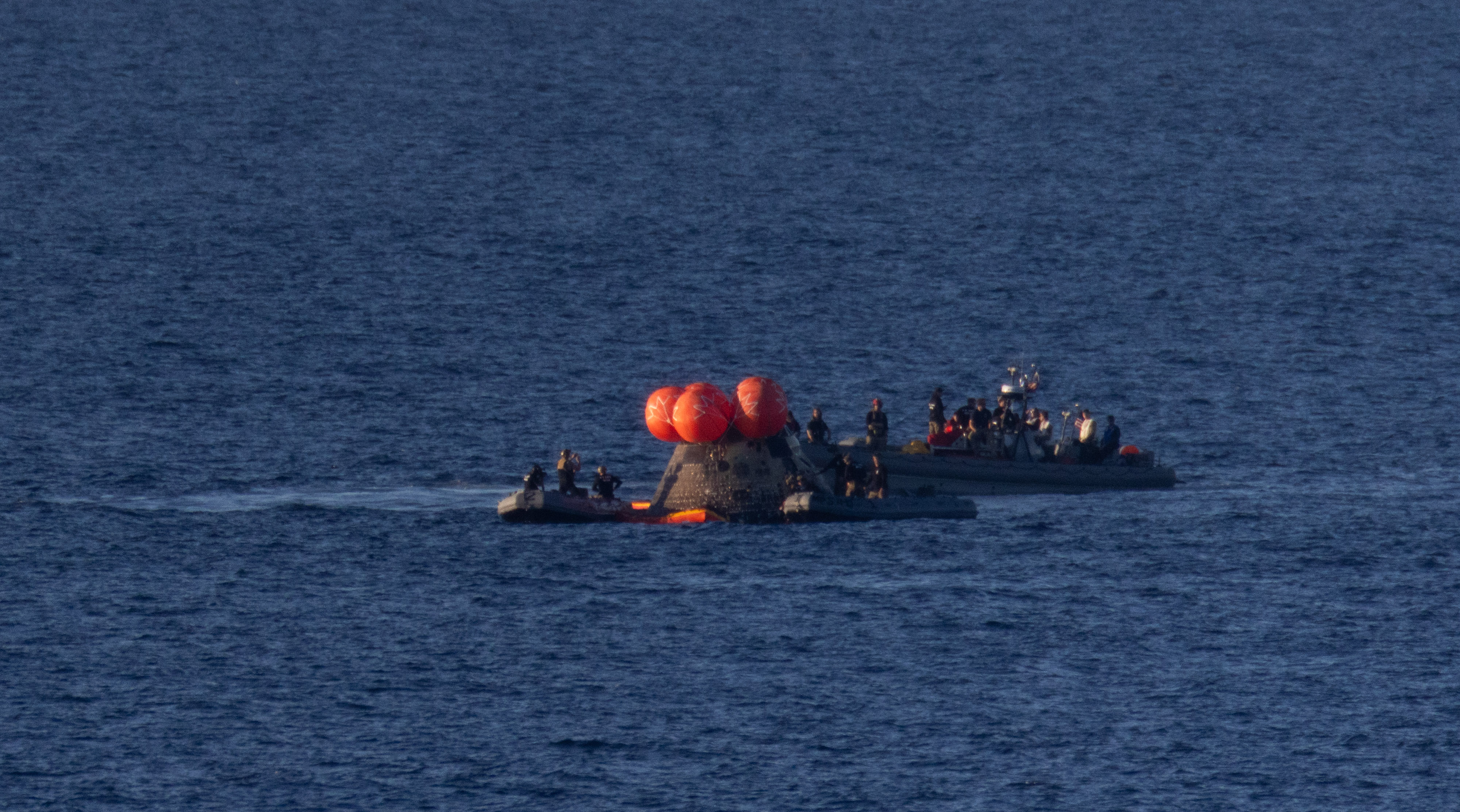 NASA’s Orion spacecraft is seen as recovery teams work to secure the spacecraft ahead of transferring Artemis II crewmembers NASA...