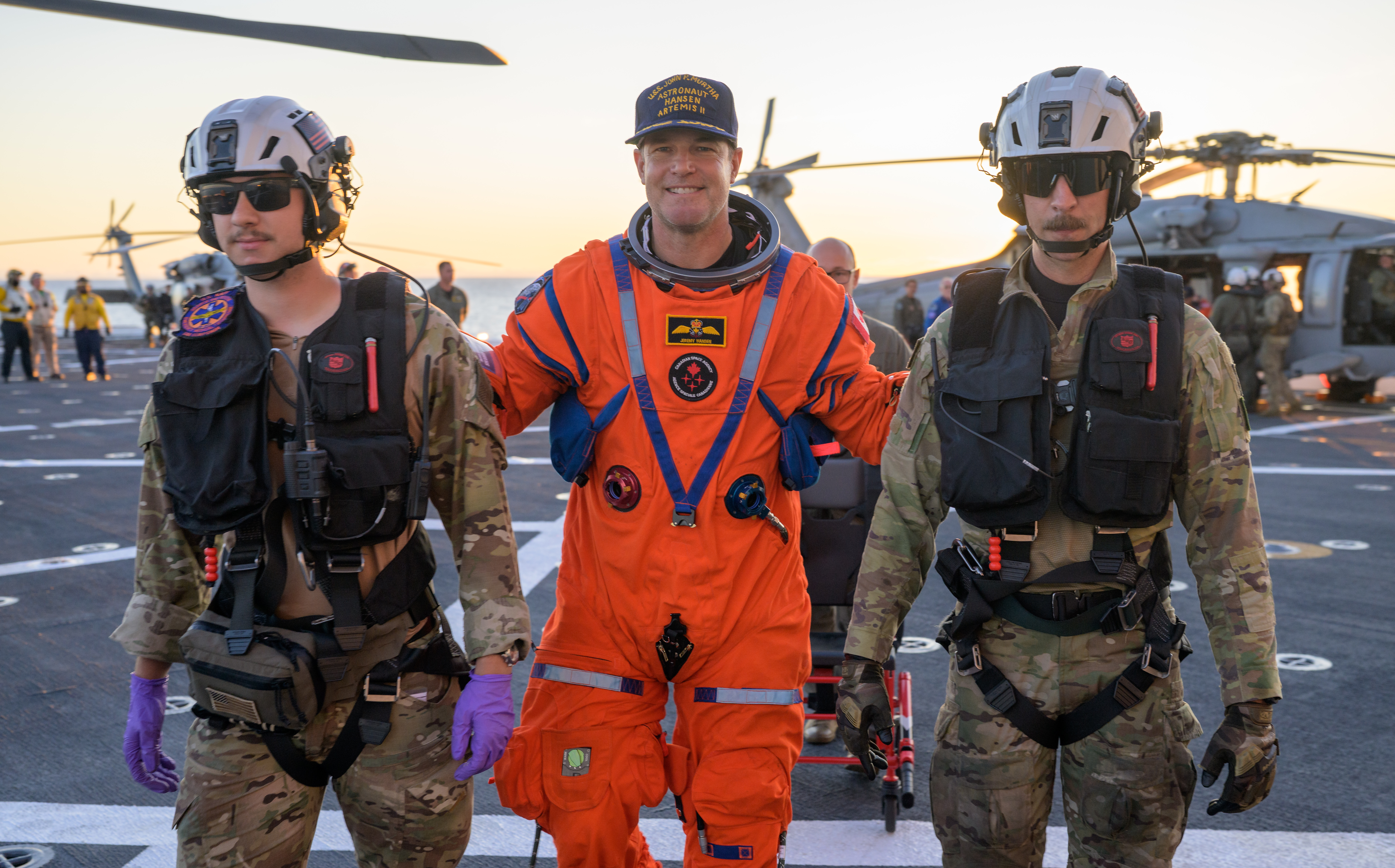 CSA (Canadian Space Agency) astronaut Jeremy Hansen, Artemis II mission specialist is assisted off the flight deck after arriving aboard...
