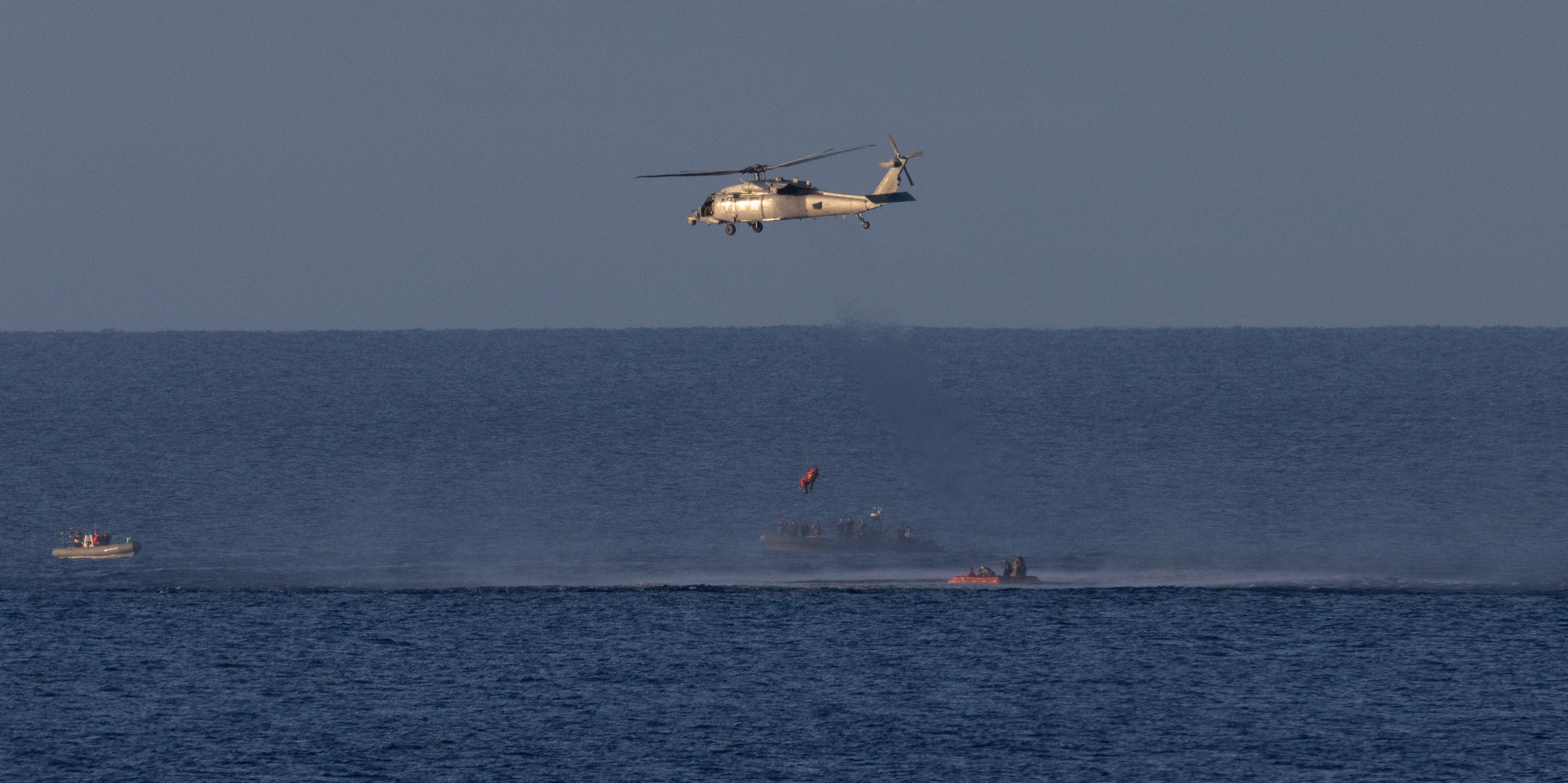 A Navy MH-60 Seahawk from Helicopter Sea Combat Squadron (HSC) 23 is seen as it lifts NASA astronaut Christina Koch,...