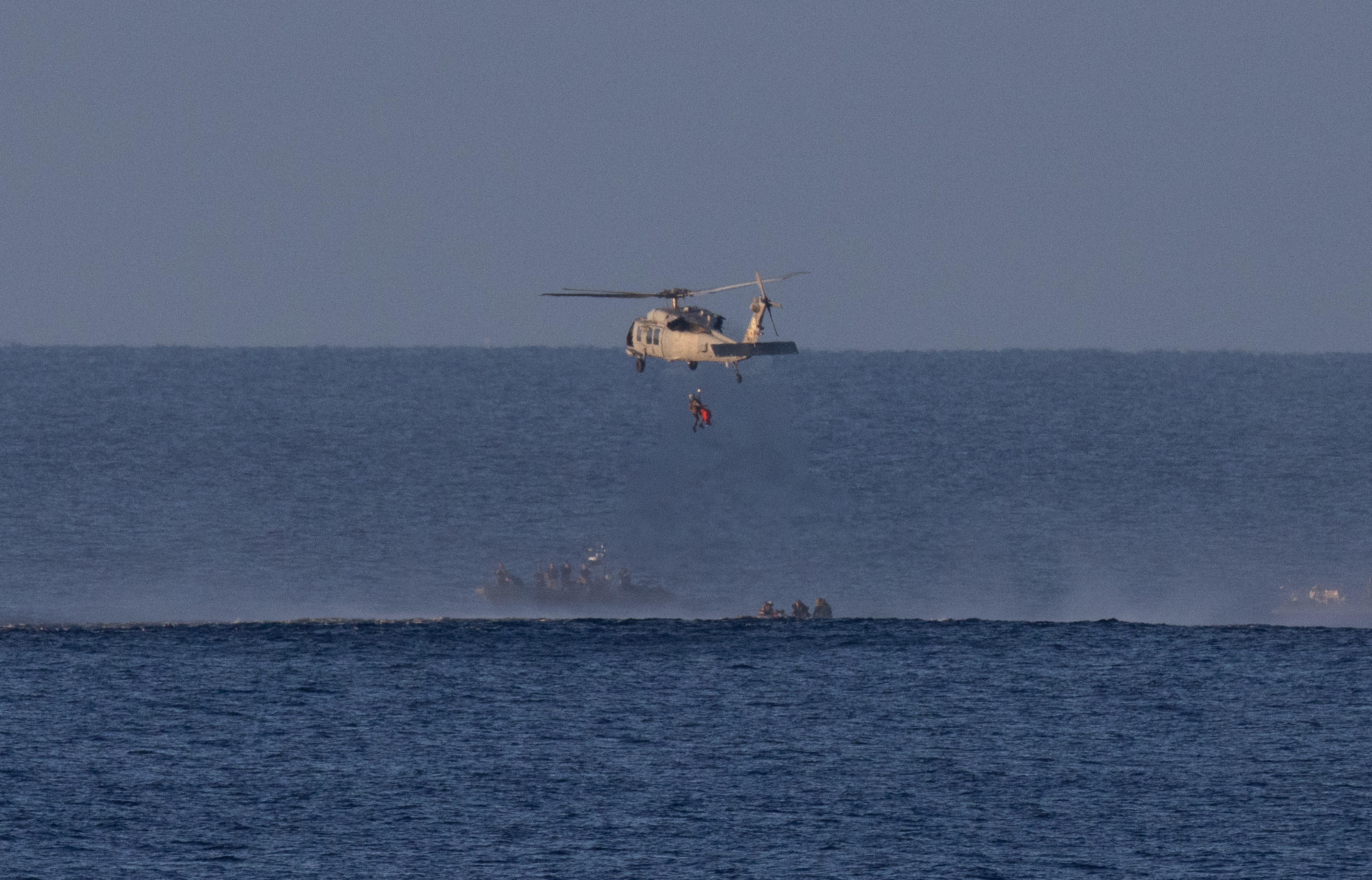 A Navy MH-60 Seahawk from Helicopter Sea Combat Squadron (HSC) 23 is seen as it lifts CSA (Canadian Space Agency)...