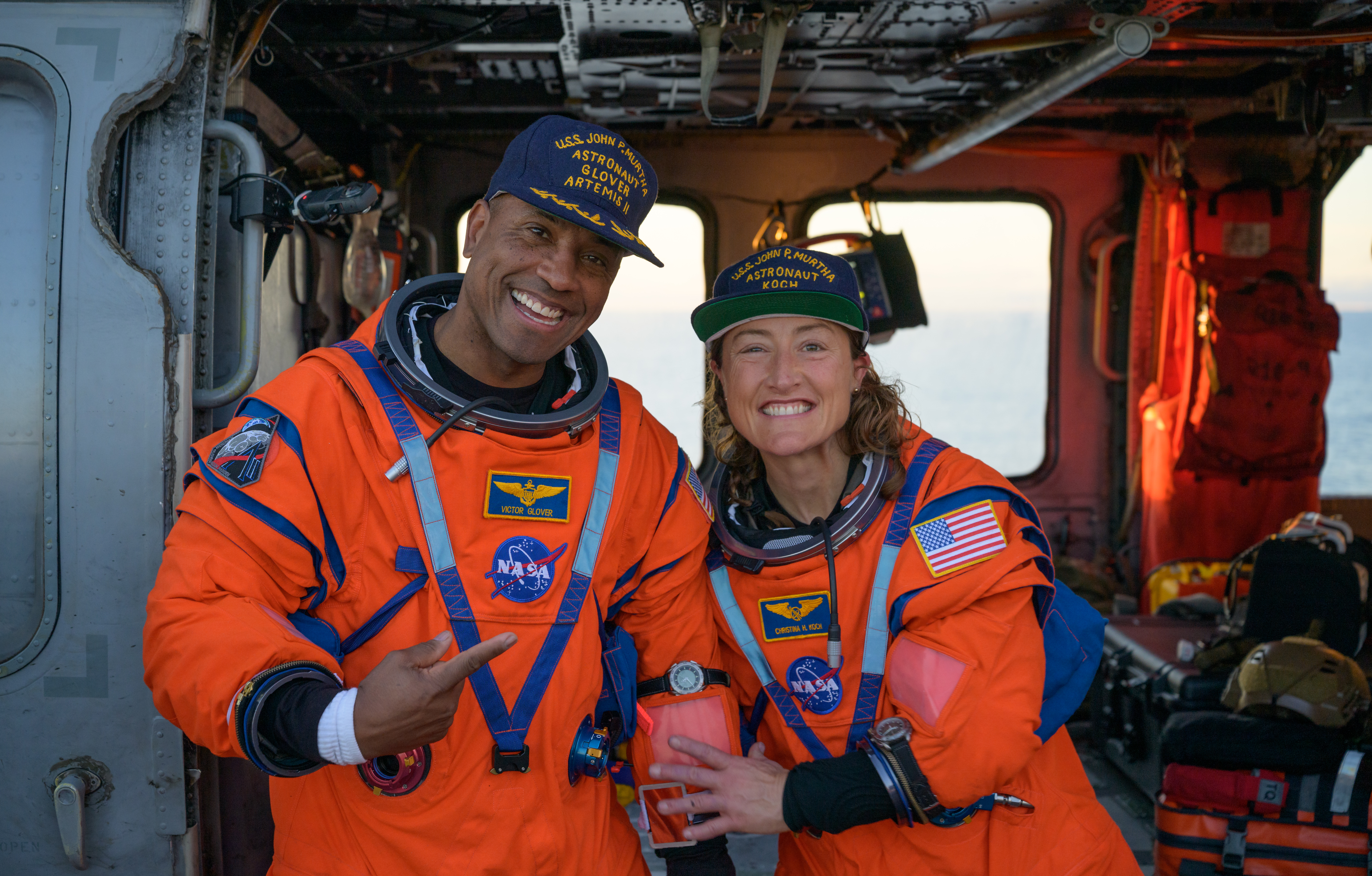 NASA astronaut Victor Glover, Artemis II pilot, left, and NASA astronaut Christina Koch, Artemis II mission specialist are seen sitting...