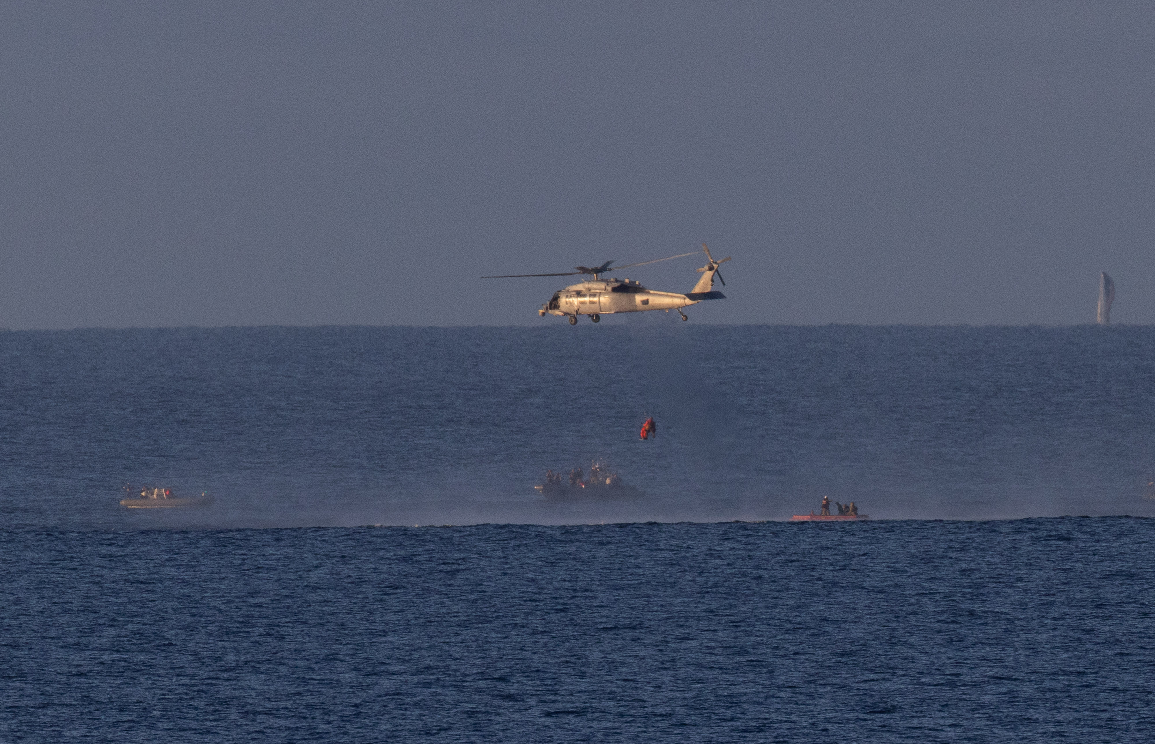 A Navy MH-60 Seahawk from Helicopter Sea Combat Squadron (HSC) 23 is seen as it lifts NASA astronaut Victor Glover,...