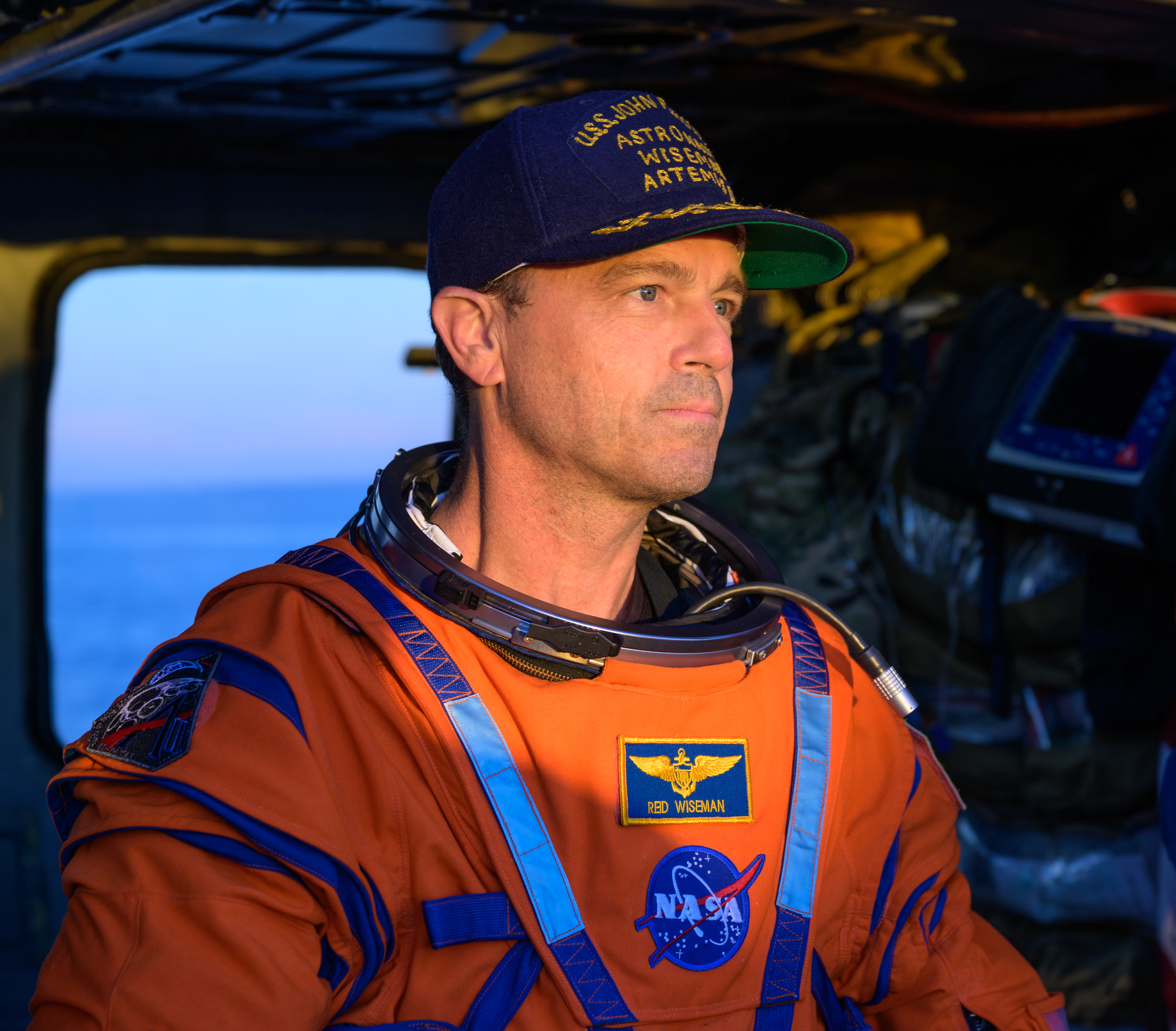 NASA astronaut Reid Wiseman, Artemis II commander is seen sitting in a Navy MH-60 Seahawk from Helicopter Sea Combat Squadron...