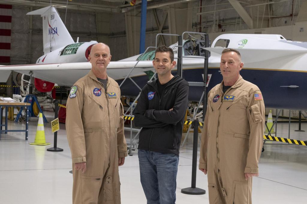 NASA Administrator Jared Isaacman, center, stands with NASA X-59 pilots Nils Larson, left, and Jim “Clue” Less.