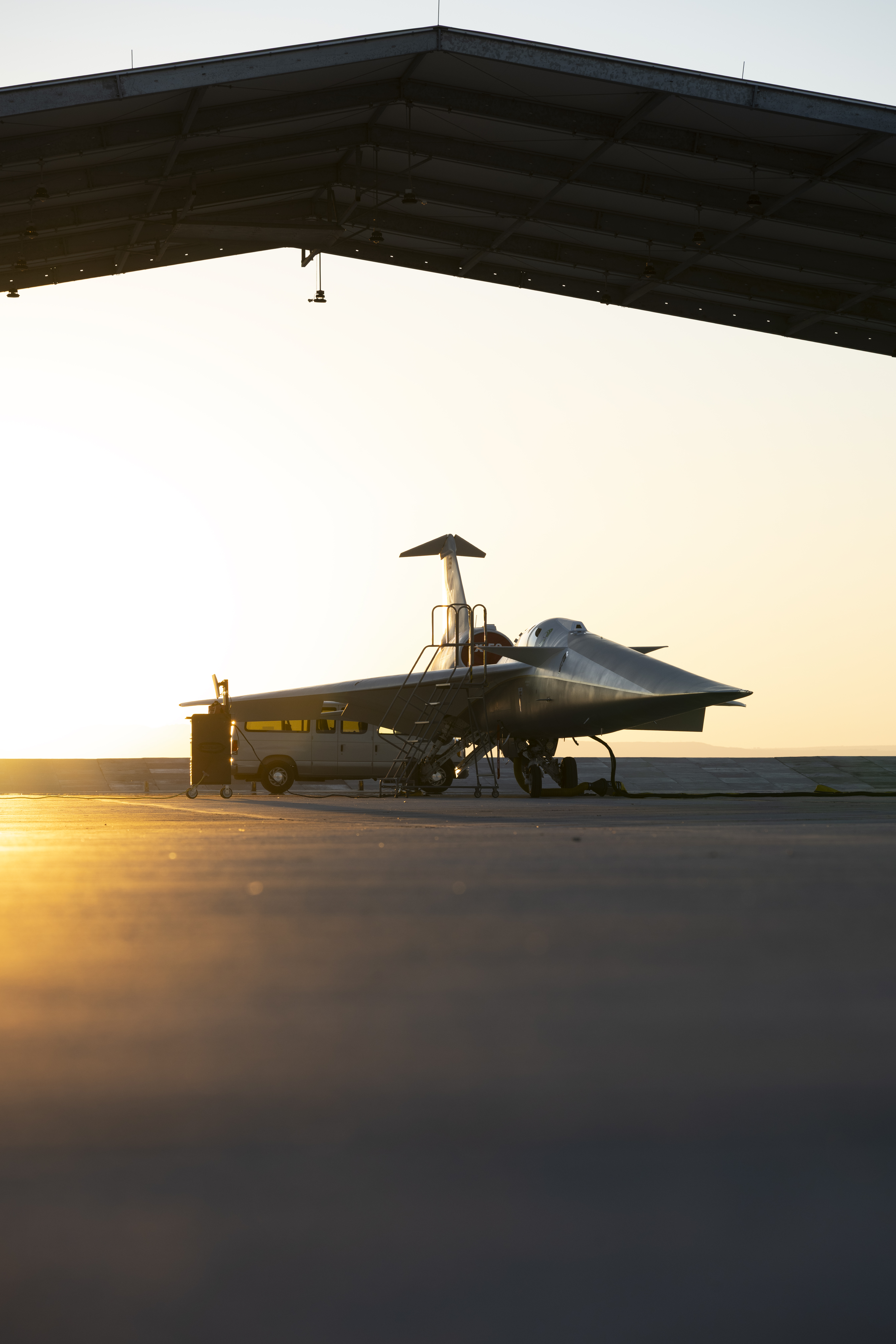 NASA's X-59 three-quarter view of the aircraft while it sits in a run stall at sunrise.